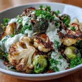 Golden-brown roasted broccoli, cauliflower, and Brussels sprouts top fluffy quinoa in this nourishing Roasted Brassica Bowl.