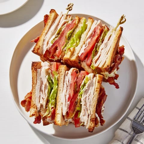 This hearty American classic sandwich is sliced diagonally into quarters and ready to serve.