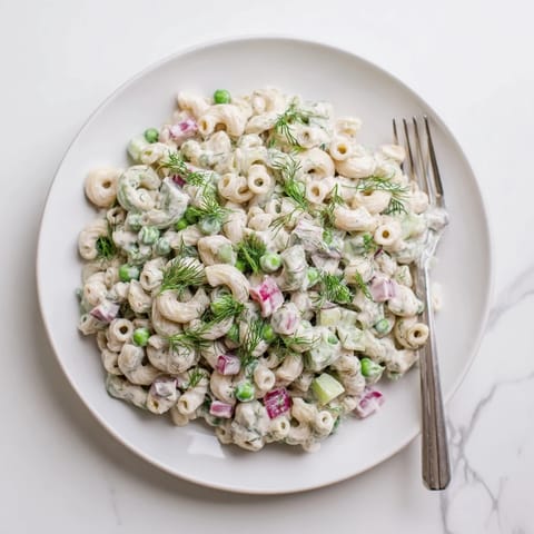 Hearty Creamy Dill Pickle Pasta Salad tossed in a tangy dressing, perfect for a summer picnic side dish.  