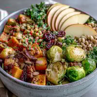 Fall Vegetable Bowl featuring golden roasted squash, Brussels sprouts, and fresh kale served over warm farro grains.