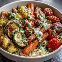 Roasted red and yellow bell peppers, broccoli, and zucchini add vibrant color to the Rainbow Roasted Vegetable Bowl over fluffy brown rice.