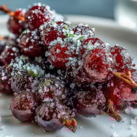 Frozen grape skewers with lime sugar sparkle on a tray, ready for a refreshing summer treat.